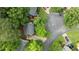 Aerial view of a home with a driveway, surrounded by lush greenery and neighboring houses at 3541 E Jameson Rd, Raleigh, NC 27604