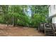 Backyard with firepit, lush trees, and a back deck for relaxing and entertaining at 3541 E Jameson Rd, Raleigh, NC 27604