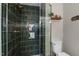 Stylish tiled shower with glass door and built in shelving in this beautifully remodeled bathroom at 3541 E Jameson Rd, Raleigh, NC 27604