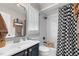 Stylish bathroom with a black and white checkered shower curtain and updated sink and fixtures at 3541 E Jameson Rd, Raleigh, NC 27604