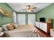 Cozy bedroom with hardwood floors, ceiling fan and white closet doors at 3541 E Jameson Rd, Raleigh, NC 27604