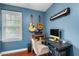 Bedroom/Office space with blue painted walls, desk, and window with natural light at 3541 E Jameson Rd, Raleigh, NC 27604