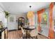 Dining area with a rattan chandelier, bright windows, and modern furniture for entertaining guests at 3541 E Jameson Rd, Raleigh, NC 27604