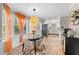 Bright dining area features hardwood floors, large windows with orange accents, and modern light fixture at 3541 E Jameson Rd, Raleigh, NC 27604