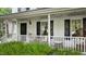 Charming home front porch featuring cozy seating and decorative details, adding to its curb appeal at 3541 E Jameson Rd, Raleigh, NC 27604