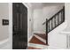 Entryway view featuring a dark front door and staircase, offering a glimpse of the home's interior at 3541 E Jameson Rd, Raleigh, NC 27604