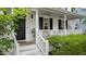 Welcoming front porch with stylish decor, creating a cozy and inviting entrance to the home at 3541 E Jameson Rd, Raleigh, NC 27604
