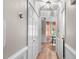 Hallway leading to dining room, featuring white trim and hardwood floors at 3541 E Jameson Rd, Raleigh, NC 27604