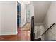 Hallway with hardwood floors offering an inside view into other rooms and staircase to the basement at 3541 E Jameson Rd, Raleigh, NC 27604