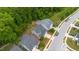 Aerial view showcases the property's boundaries, placement on the lot, and surrounding wooded area at 4001 Bostwyck Dr, Fuquay Varina, NC 27526