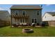 A backyard with a patio, fire pit, and pergola-covered seating area at 4001 Bostwyck Dr, Fuquay Varina, NC 27526