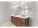 Bathroom with double vanity sinks and a large mirror illuminated with overhead lights at 4001 Bostwyck Dr, Fuquay Varina, NC 27526