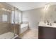 This bathroom includes a glass enclosed shower and garden tub, with a vanity to the right at 4001 Bostwyck Dr, Fuquay Varina, NC 27526