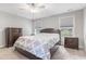 Cozy bedroom featuring two windows, neutral colors, and ceiling fan at 4001 Bostwyck Dr, Fuquay Varina, NC 27526