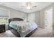 Well-lit bedroom with a large bed, soft carpet, and a ceiling fan at 4001 Bostwyck Dr, Fuquay Varina, NC 27526