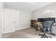 This bedroom features a desk, chair, and bookshelf, with a door to the left at 4001 Bostwyck Dr, Fuquay Varina, NC 27526