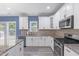 Modern kitchen featuring white cabinets, granite countertops, stainless steel appliances, and a breakfast bar at 4001 Bostwyck Dr, Fuquay Varina, NC 27526