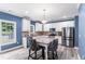 Bright kitchen with white cabinets, granite countertops, stainless steel appliances, and a center island at 4001 Bostwyck Dr, Fuquay Varina, NC 27526