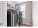 Modern laundry room features a side-by-side washer and dryer set with shelving at 4001 Bostwyck Dr, Fuquay Varina, NC 27526