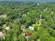 An aerial view displays a home with a pool amid a lush, green canopy at 4112 Rowan St, Raleigh, NC 27609