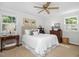 Bright bedroom with neutral walls, vintage furnishings and a ceiling fan at 4112 Rowan St, Raleigh, NC 27609