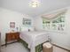 Bedroom featuring a floral bedspread, side tables, and a large window at 4112 Rowan St, Raleigh, NC 27609