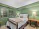 Traditional bedroom featuring a full-sized bed with antique wooden frame and sewing machine side table at 4112 Rowan St, Raleigh, NC 27609