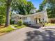 Inviting exterior with a brick facade, well-manicured lawn, and a covered carport for convenient parking at 4112 Rowan St, Raleigh, NC 27609