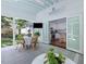 Covered patio features a dining area with an outdoor ceiling fan and access to the kitchen at 4112 Rowan St, Raleigh, NC 27609