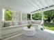 The screened in porch features a large seating area with a white wood paneled ceiling at 4112 Rowan St, Raleigh, NC 27609