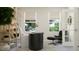 Bright home office with a modern desk, shelving, and comfortable seating area with natural light at 4308 Hunters Brook Run, Raleigh, NC 27616