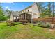 Expansive backyard featuring a screened porch, fire pit, garden beds, and metal stock tank pool at 4412 Thistlehill Ct, Raleigh, NC 27616