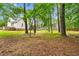 Lush backyard offering natural beauty with mature trees, providing a serene outdoor space at 4412 Thistlehill Ct, Raleigh, NC 27616