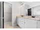 This spacious bathroom features dual sinks and granite countertops and ceramic tile at 4412 Thistlehill Ct, Raleigh, NC 27616