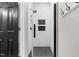 Sleek modern bathroom featuring white subway tile, glass door, and black hardware at 4412 Thistlehill Ct, Raleigh, NC 27616