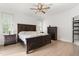 Spacious bedroom with hardwood floors, ceiling fan and a large wooden bed frame with matching dresser at 4412 Thistlehill Ct, Raleigh, NC 27616