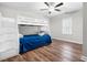 Cozy bedroom featuring a bunk bed, wood look floors, white trim, and a ceiling fan at 4412 Thistlehill Ct, Raleigh, NC 27616