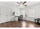 Bedroom featuring a ceiling fan, wood flooring, windows, and a door to the closet at 4412 Thistlehill Ct, Raleigh, NC 27616