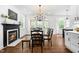 Inviting dining area with fireplace, hardwood floors, and ample natural light at 4412 Thistlehill Ct, Raleigh, NC 27616