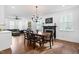 Bright dining room features a fireplace, wood floors, and view into the living room at 4412 Thistlehill Ct, Raleigh, NC 27616