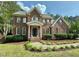 Beautiful brick home with lush landscaping and a welcoming front porch at 4412 Thistlehill Ct, Raleigh, NC 27616