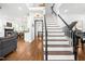 Elegant foyer with hardwood floors, staircase, and open view to dining and living areas at 4412 Thistlehill Ct, Raleigh, NC 27616