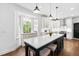 Bright kitchen featuring an island with bar seating, a bay window and hardwood flooring at 4412 Thistlehill Ct, Raleigh, NC 27616