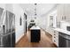 Bright kitchen featuring an island with bar seating, stainless steel appliances and hardwood flooring at 4412 Thistlehill Ct, Raleigh, NC 27616