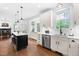 Bright kitchen featuring an island with bar seating, stainless steel appliances and hardwood flooring at 4412 Thistlehill Ct, Raleigh, NC 27616