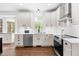 Bright kitchen featuring stainless steel appliances, subway tile backsplash and hardwood flooring at 4412 Thistlehill Ct, Raleigh, NC 27616