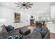 Comfortable living room with a fireplace, hardwood floors, and a gray sofa at 4412 Thistlehill Ct, Raleigh, NC 27616