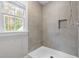 Modern shower with neutral tile, niche, glass door and a handheld shower head at 4412 Thistlehill Ct, Raleigh, NC 27616