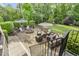 Beautiful backyard featuring an outdoor kitchen, fire pit, seating area, and landscaped greenery at 5112 Highbury Grove Ln, Fuquay Varina, NC 27526