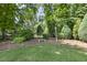 Beautiful backyard landscaping with mature trees, shrubs, and a well-manicured lawn at 5112 Highbury Grove Ln, Fuquay Varina, NC 27526